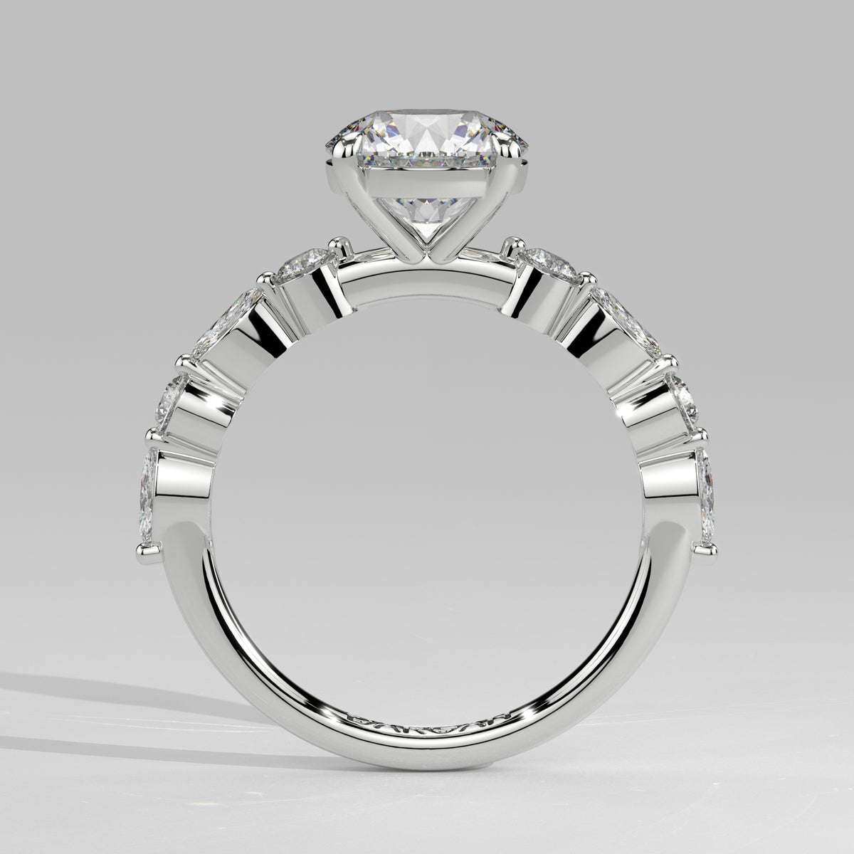 Orbis Round lab-grown diamond solitaire ring with marquise and round side stones in 18K white gold, front-on view of the band and setting