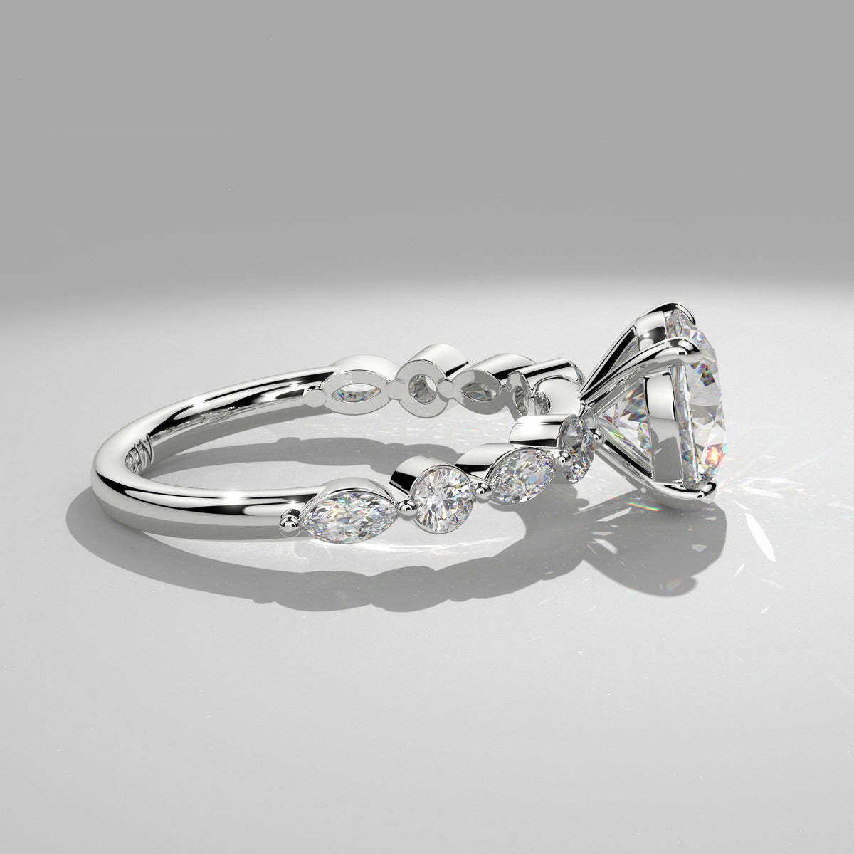 Orbis Round lab-grown diamond solitaire ring with marquise and round side stones in 18K white gold, side profile of marquise and round band