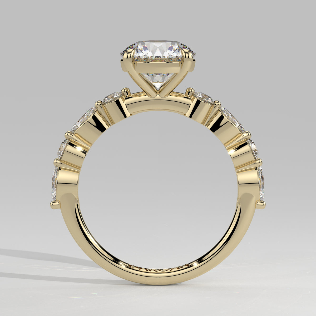 Orbis Round lab-grown diamond solitaire ring with marquise and round side stones in 18K yellow gold, front-on view of the band and setting